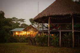 Chuncho Lodge cabins lit at night in the Amazon rainforest