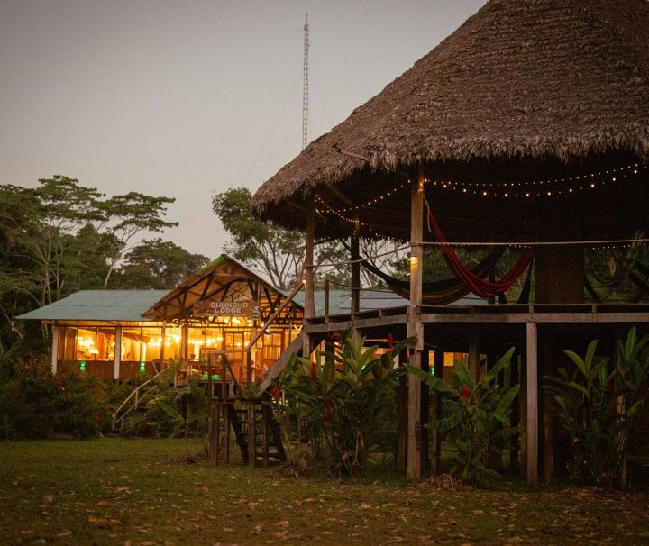 Chuncho Lodge cabins lit at night in the Amazon rainforest