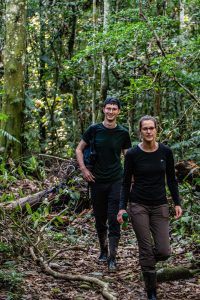 Two travelers posing in the middle of the Amazon rainforest trail